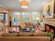 Cozy living room with fireplace, hardwood floors, and plenty of natural light at 4510 Old Course Dr, Charlotte, NC 28277