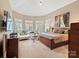 Serene main bedroom with vaulted ceiling, bay windows with shutters, and an elegant decor at 4510 Old Course Dr, Charlotte, NC 28277