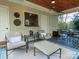 Comfortable outdoor seating area with a patterned rug and view into a living space with natural light and stylish decor at 4510 Old Course Dr, Charlotte, NC 28277