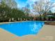 Refreshing pool surrounded by lush landscaping and lounge chairs, perfect for relaxation and outdoor enjoyment at 4510 Old Course Dr, Charlotte, NC 28277