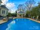Beautiful backyard with a pool, cabana, and meticulously landscaped grounds at 4510 Old Course Dr, Charlotte, NC 28277