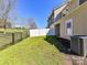 Backyard with a well-maintained lawn and black metal fence at 4634 Craigmoss Ln, Charlotte, NC 28278