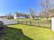 Fenced backyard with lush green grass and a view of neighboring townhomes at 4634 Craigmoss Ln, Charlotte, NC 28278