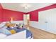bedroom featuring a bright pink accent wall, hardwood floors, and a closet at 4634 Craigmoss Ln, Charlotte, NC 28278