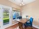 Bright breakfast area with wood table and walk-out to backyard at 4634 Craigmoss Ln, Charlotte, NC 28278
