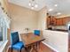 Bright breakfast area with wood table, blue chairs, and natural lighting at 4634 Craigmoss Ln, Charlotte, NC 28278