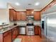 Well-lit kitchen with stainless steel appliances and warm wood cabinets at 4634 Craigmoss Ln, Charlotte, NC 28278
