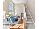 Open-concept living room boasts hardwood floors, fireplace, and staircase at 4634 Craigmoss Ln, Charlotte, NC 28278