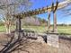Park featuring a wooden swing, stone pillars, and a serene landscape at 4634 Craigmoss Ln, Charlotte, NC 28278