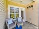 Cozy covered patio featuring comfortable chairs and an outdoor heater at 4634 Craigmoss Ln, Charlotte, NC 28278
