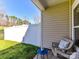 Cozy patio with a comfortable chair and view of the grassy yard at 4634 Craigmoss Ln, Charlotte, NC 28278
