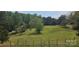 Picturesque backyard with expansive grassy area and wood fence at 4790 Polk Ford Rd, Stanfield, NC 28163