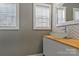 Stylish bathroom featuring a glass bowl sink, wood counter, and chevron tile backsplash at 4790 Polk Ford Rd, Stanfield, NC 28163