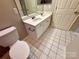 Bright bathroom with dual sinks, white cabinets, and tiled floor at 4930 Sardis Rd # C, Charlotte, NC 28270