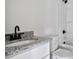 Updated bathroom featuring granite counters, modern fixtures, and a tub-shower combination at 513 Harrel St, Salisbury, NC 28144