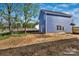 A blue home exterior, complemented by a neatly landscaped lawn at 513 Harrel St, Salisbury, NC 28144