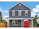 Two-story home featuring blue siding, black shutters, and white trim details, with a covered porch at 513 Harrel St, Salisbury, NC 28144