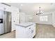 Open floor plan featuring a kitchen island with granite countertops, new flooring, and stainless steel appliances at 513 Harrel St, Salisbury, NC 28144