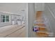 A new kitchen with white cabinets visible from unfinished stairs at 513 Harrel St, Salisbury, NC 28144