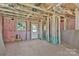 An unfinished living room and interior view reveals the home's frame with visible insulation at 513 Harrel St, Salisbury, NC 28144