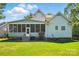 Spacious backyard featuring a screened porch, lush green lawn, and well-maintained landscaping at 8008 Battersea Ct, Waxhaw, NC 28173