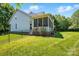 Expansive backyard showcasing a screened porch, black metal fence, and verdant grass at 8008 Battersea Ct, Waxhaw, NC 28173