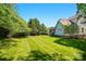 Expansive backyard with lush lawn, mature trees, and plenty of room to enjoy the outdoors at 8008 Battersea Ct, Waxhaw, NC 28173