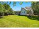 Vast backyard with a screened-in porch, lush lawn, and plenty of shade trees at 8008 Battersea Ct, Waxhaw, NC 28173
