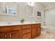 Bright bathroom featuring a double sink vanity, and tub shower at 8008 Battersea Ct, Waxhaw, NC 28173