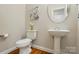 Stylish powder room features pedestal sink, modern fixtures, and hardwood floors at 8008 Battersea Ct, Waxhaw, NC 28173