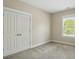 Bright bedroom with a large window and a spacious closet for ample storage at 8008 Battersea Ct, Waxhaw, NC 28173