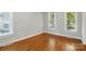 Spacious bedroom boasts hardwood floors, large windows, and modern trim and baseboards at 8008 Battersea Ct, Waxhaw, NC 28173