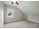 Cozy bedroom featuring neutral walls, carpet, and a window with a view at 8008 Battersea Ct, Waxhaw, NC 28173