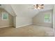 Large bedroom with neutral walls, carpet, two windows, and a door to storage at 8008 Battersea Ct, Waxhaw, NC 28173