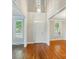 Bright foyer with hardwood floors, transom windows, and white trim, leading to other rooms at 8008 Battersea Ct, Waxhaw, NC 28173