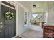 Inviting front porch with a porch swing, brick accents, and a decorative wreath on the front door at 8008 Battersea Ct, Waxhaw, NC 28173
