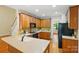 Well-equipped kitchen with hardwood cabinets, countertops, and modern appliances, flowing into an eat-in area at 8008 Battersea Ct, Waxhaw, NC 28173