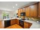 Bright kitchen features wooden cabinets, stone backsplash, stainless steel appliances, and white countertops at 8008 Battersea Ct, Waxhaw, NC 28173
