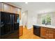 Kitchen features wooden cabinets, modern appliances, and an adjoining bathroom and living space at 8008 Battersea Ct, Waxhaw, NC 28173