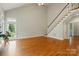 Bright living room featuring tall ceilings, hardwood floors, a staircase, and lots of natural light at 8008 Battersea Ct, Waxhaw, NC 28173