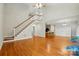 Spacious living area showcasing hardwood floors, a staircase, and open access to the kitchen and dining area at 8008 Battersea Ct, Waxhaw, NC 28173