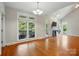 Bright living room boasts vaulted ceilings, large windows, hardwood floors, and a cozy fireplace at 8008 Battersea Ct, Waxhaw, NC 28173
