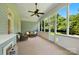Screened porch featuring wicker furniture, a ceiling fan, and nice backyard views at 8008 Battersea Ct, Waxhaw, NC 28173