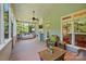 Screened porch featuring wicker furniture, an outdoor swing, and nice backyard views at 8008 Battersea Ct, Waxhaw, NC 28173