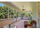 Screened porch featuring wicker furniture, an outdoor swing, and pretty views at 8008 Battersea Ct, Waxhaw, NC 28173