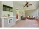 Screened porch featuring wicker furniture, a ceiling fan, and an outdoor TV at 8008 Battersea Ct, Waxhaw, NC 28173