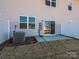 Backyard featuring a sliding glass door to patio, air conditioning unit, utility box, and privacy fence at 8021 Lerwick Trl, Charlotte, NC 28269