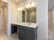 Modern bathroom featuring vanity with dual sinks, ample lighting, and a glass-enclosed shower at 8021 Lerwick Trl, Charlotte, NC 28269