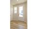 Bright entryway featuring wood-look flooring, white trim, and a glass-paneled front door for natural light at 8021 Lerwick Trl, Charlotte, NC 28269