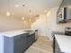 Bright and modern kitchen featuring a large island, stainless steel appliances and elegant pendant lighting at 8021 Lerwick Trl, Charlotte, NC 28269